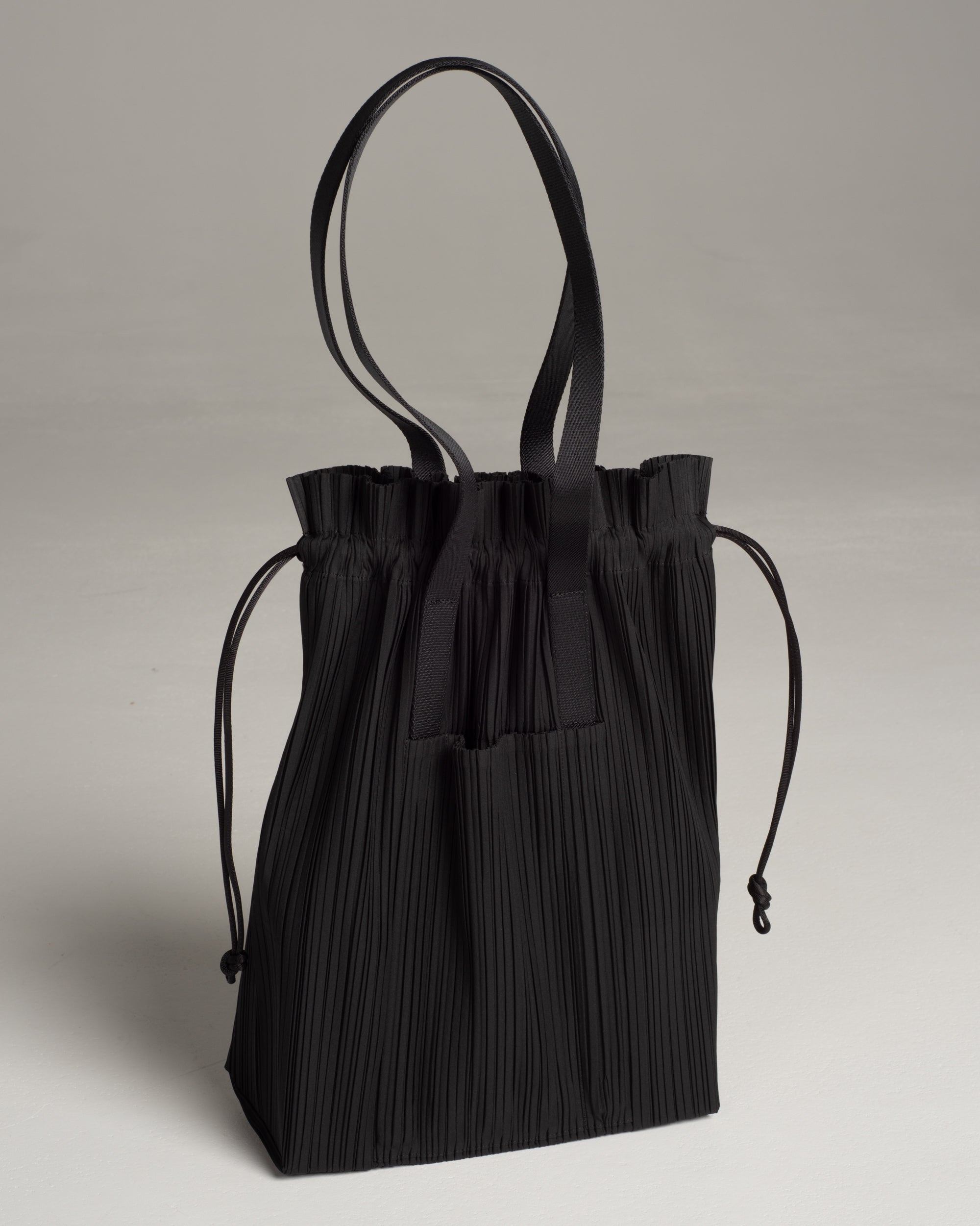 Pleats Please Issey Miyake Pleated Drawstring Backpack in Black